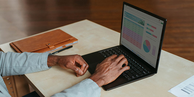 A person adding a pie chart on a laptop