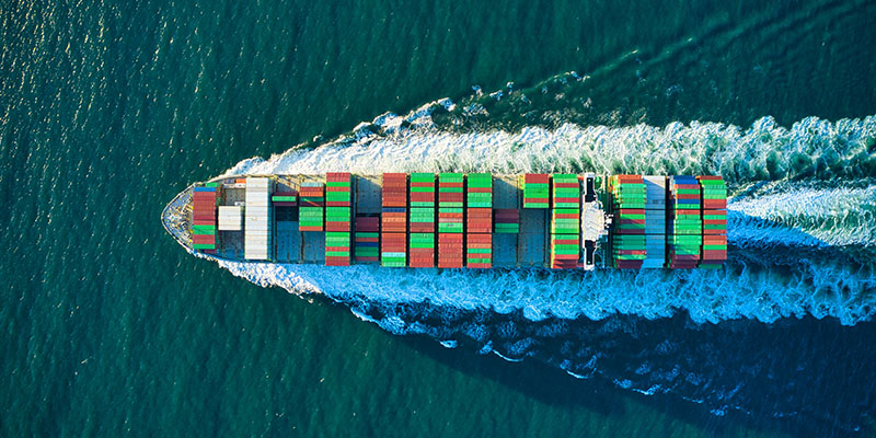 Cargo ship loaded with containers sailing in ocean