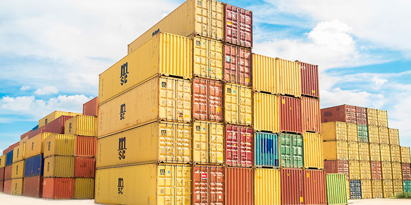 Shipping containers stacked one above the other on an ocean port