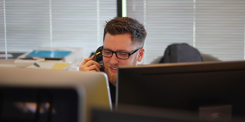 A young man talking on a phone 