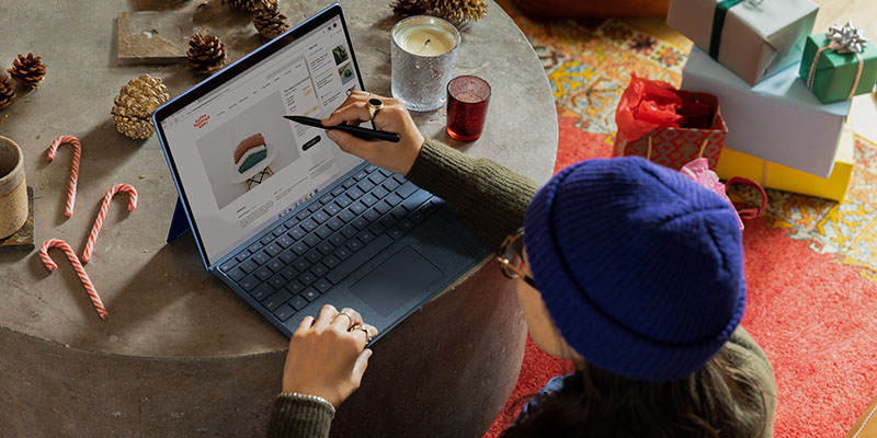 Woman using Surface Pro to design online store