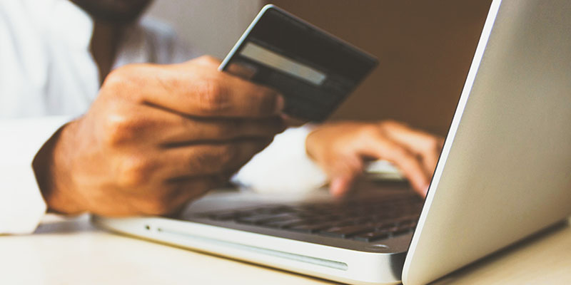 A person using laptop to making payment using credit card