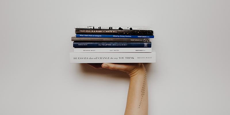 A hand balancing books