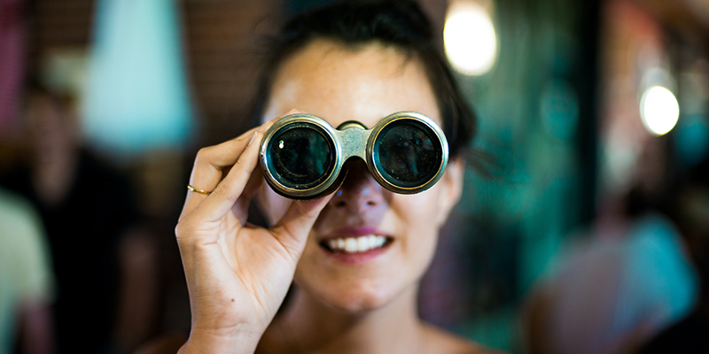 A woman using binoculars