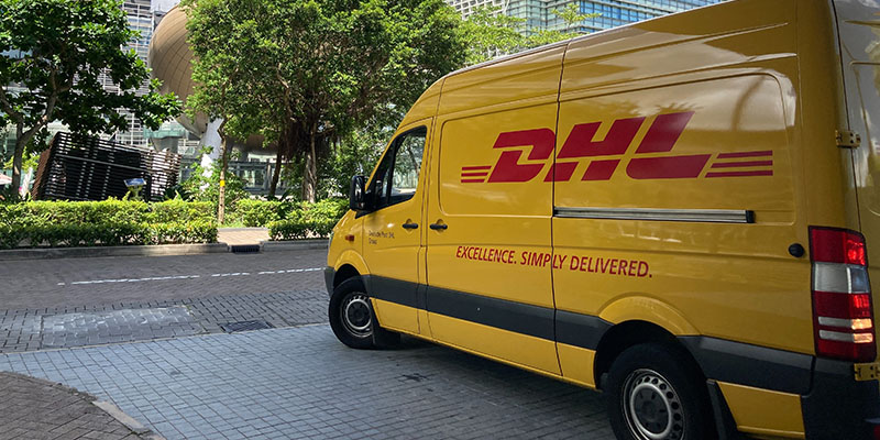 DHL van parked near a commercial hub