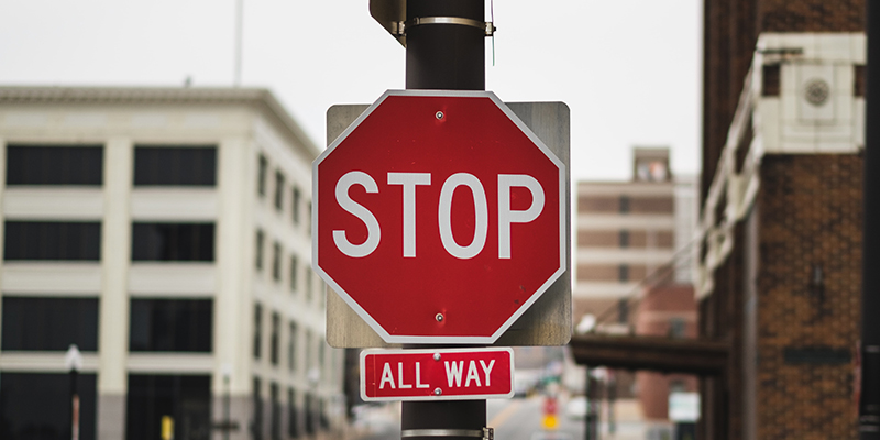 Stop all the way sign