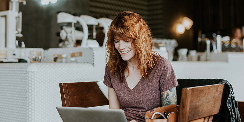 Tattooed woman with laptop