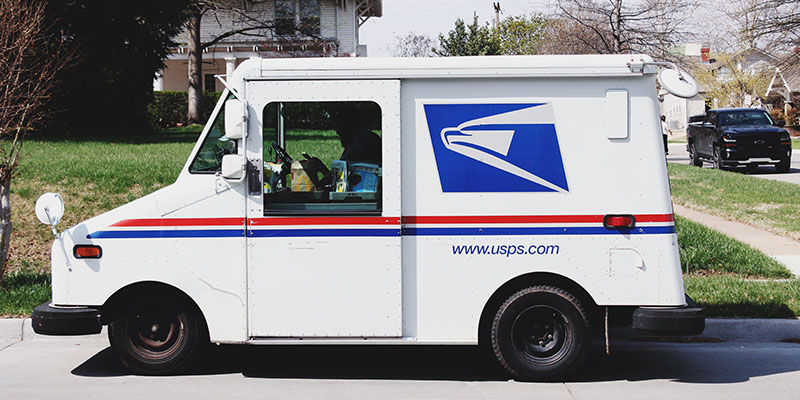 USPS van in a suburb