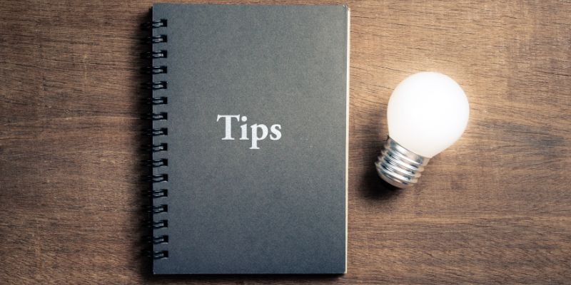 notebook on a table beside a lightbulb