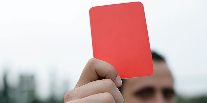 A referee holding a red card