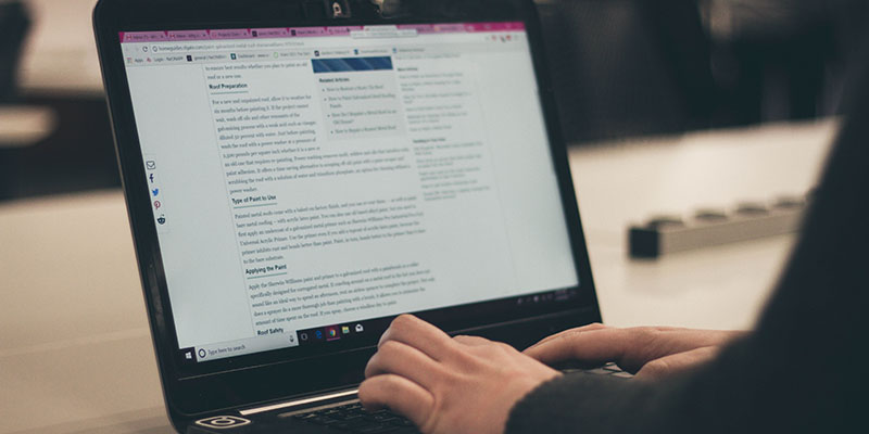 Closeup of a person typing on a laptop