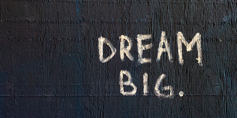 Dream big written on a black wall