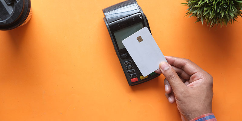 A man tapping a POS terminal for payment