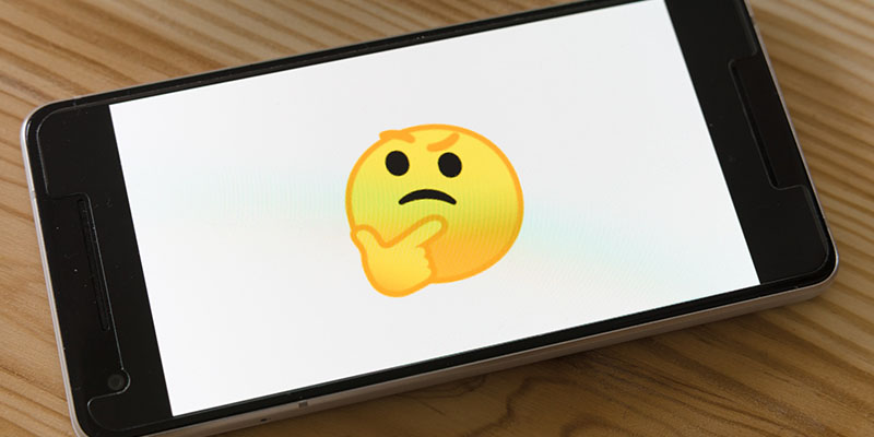 A thinking Yellow emoji on a cell phone