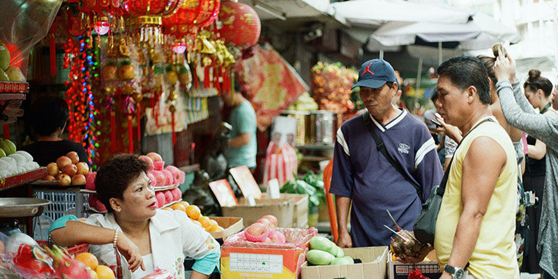 A man buying a fruit from a Chinese shop