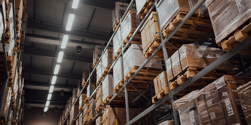 Multiple pallets stacked in a large warehouse