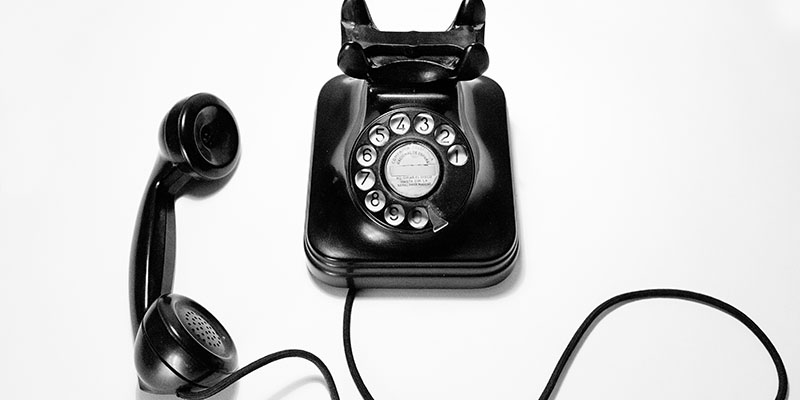 A Black vintage telephone on a White table