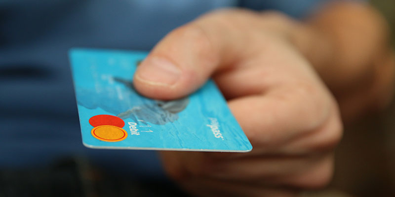 A hand showing a credit card
