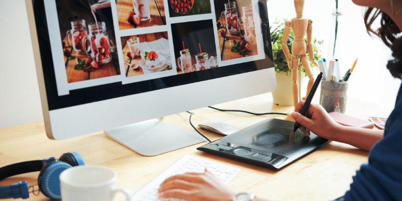 woman looking at photos on a desktop computer