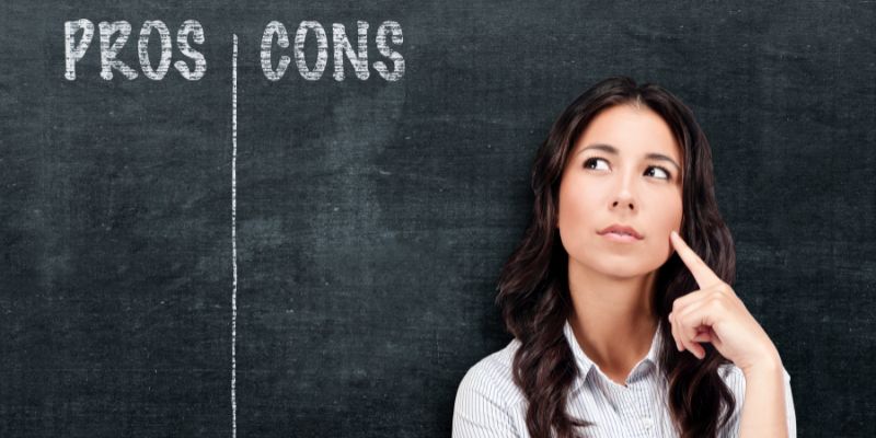 woman standing by a chalkboard with the words pros and cons