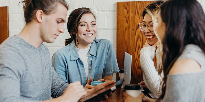 A group of four interacting at a cafe