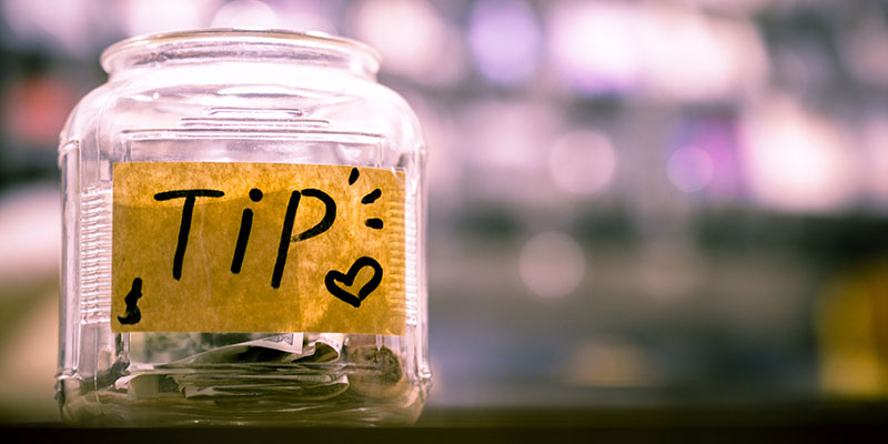 A "Tip" labeled jar with money 