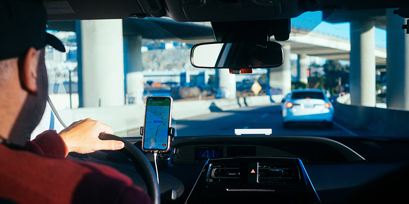 An Uber driver driving under a bridge