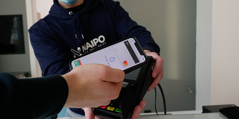 A man swiping his card on a POS machine