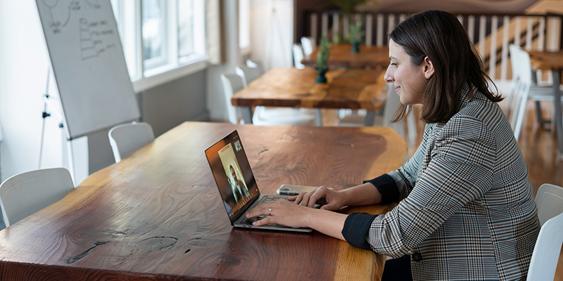 A young woman attending a video call on her laptop