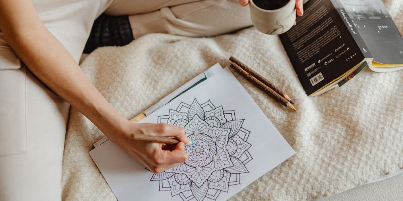 Woman coloring a design on paper