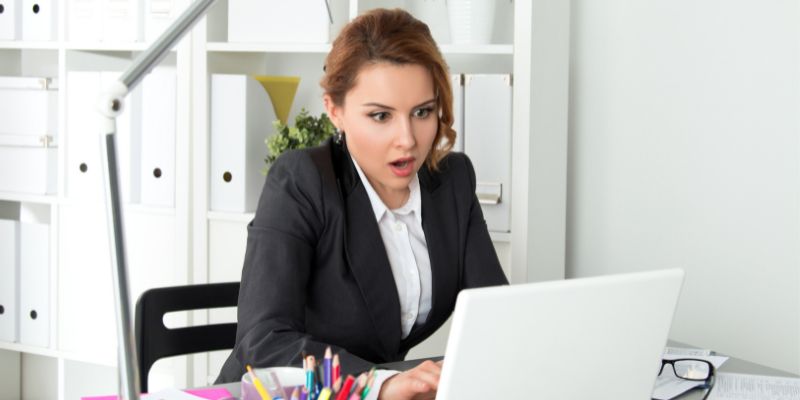 woman at a laptop with a surprised look