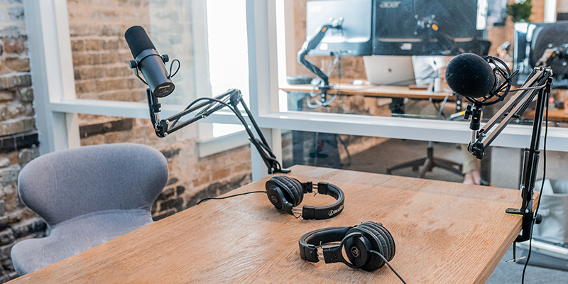 Podcast equipmemnt setup on a brown table