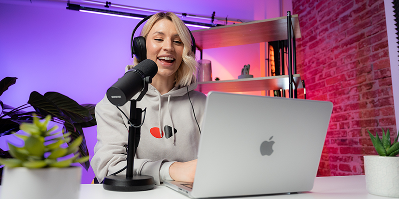 A young woman recording video for her channel