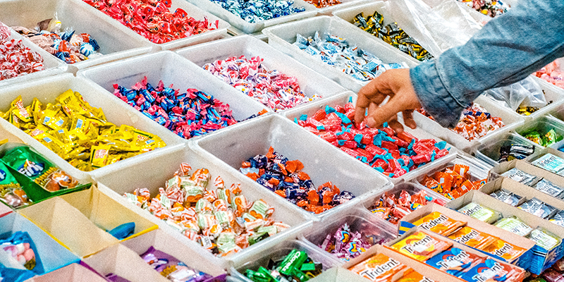 a hand picking a candy