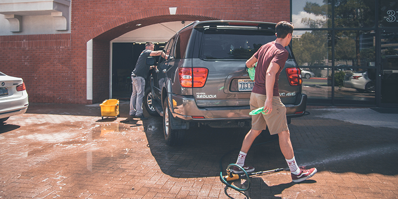 Dad and son washing their car