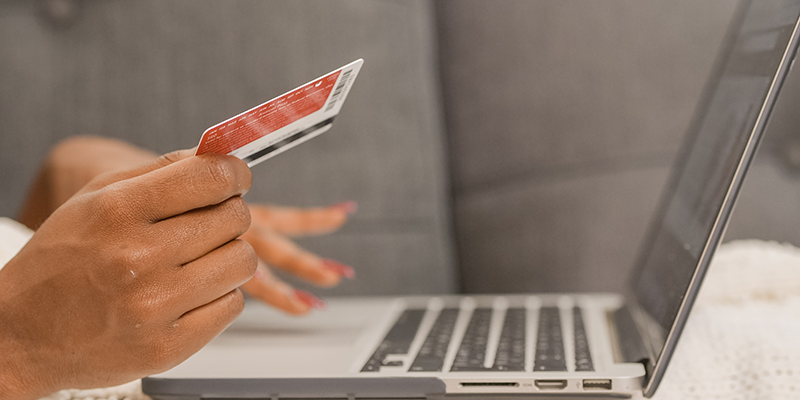 Person holding credit card doing online shopping