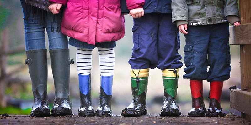 Four kids playing in the mud