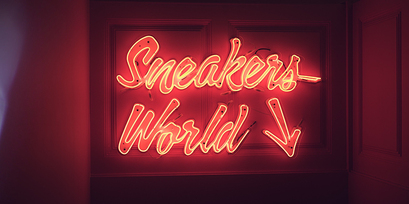 Sneaker World Red neon lighting against a dark color wall