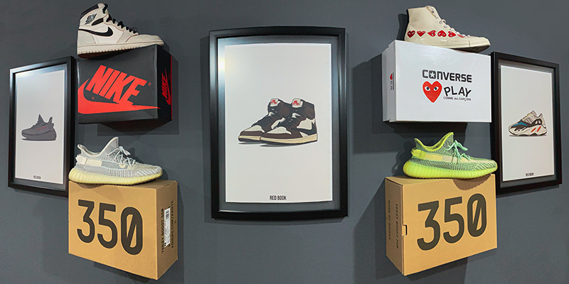 Different sneakers on display against a dark grey wall