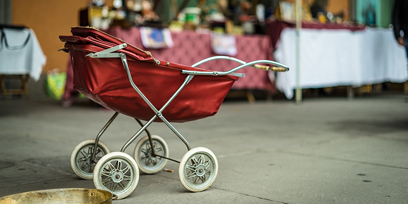 A red stroller in the market 
