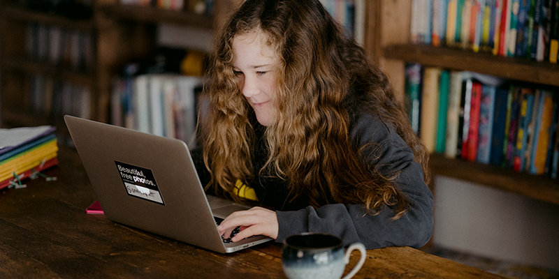 Young teen doing schoolwork at home