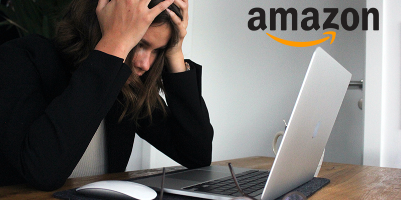 An Amazon seller is stressed and frustrated looking at their laptop screen