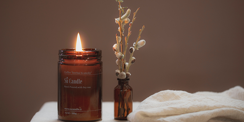 Candle and flowers on a bedside table
