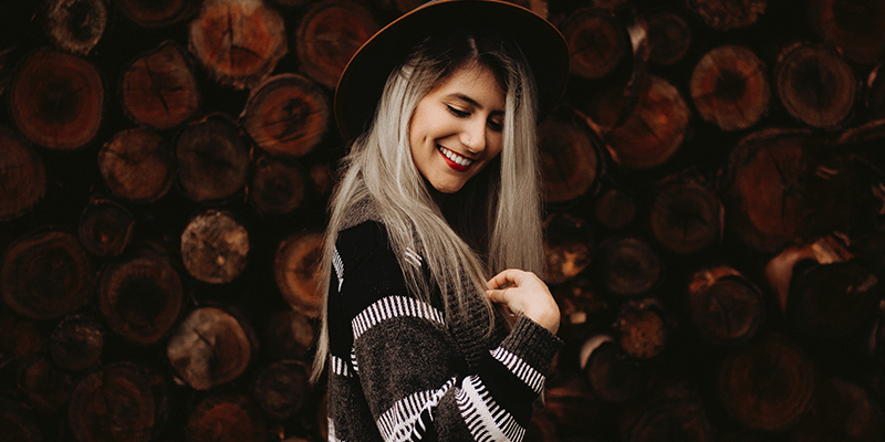 A teen model wearing a hat and winter clothes