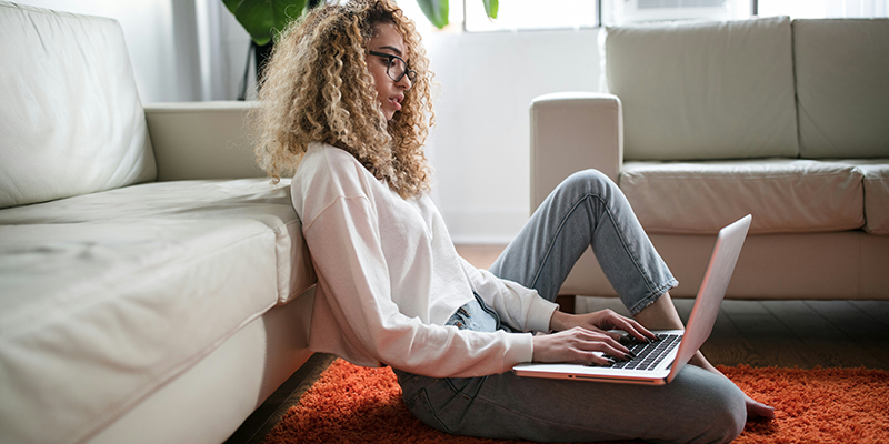 A teen working on her laptop