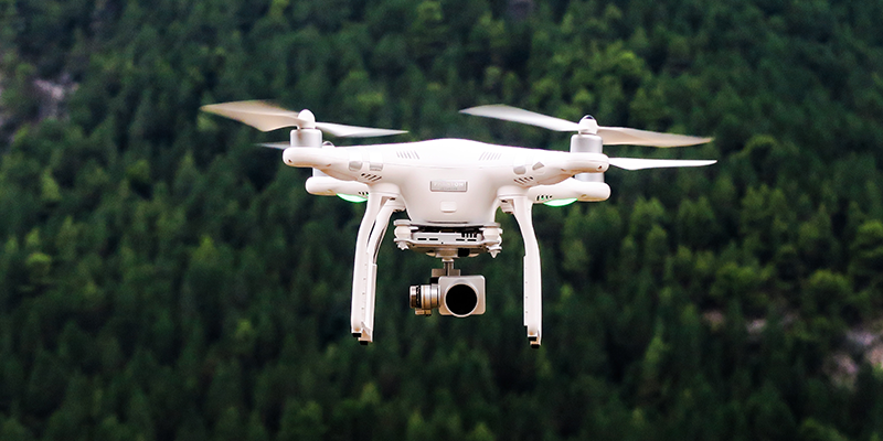 White drone mid-flight