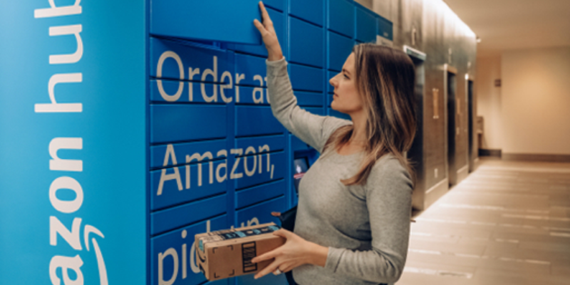 A woman picking up her parcel from an Amazon Hub Locker