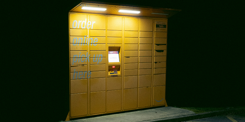 A yellow color parcel locker in a parking lot